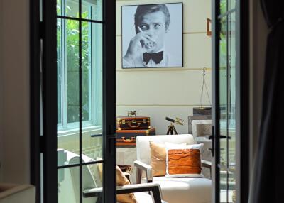 Elegant living room viewed through French doors with natural light