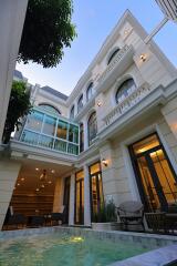 Luxurious two-story building with swimming pool at twilight