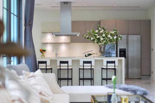 Modern kitchen interior with white flowers on the island and stainless steel appliances