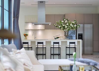 Modern kitchen interior with white flowers on the island and stainless steel appliances