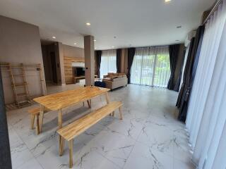 Spacious and modern living room with dining area and access to natural light