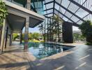 Modern outdoor swimming pool with shaded lounge area and landscaping