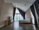 Modern bedroom with large windows and dark wood flooring