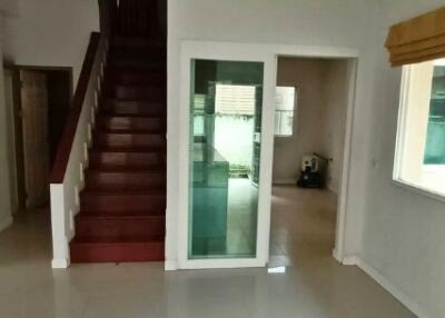 Interior view of a home with staircase and entrance