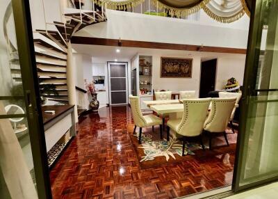 Elegant dining area with spiral staircase and decorative flooring