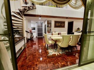 Elegant dining area with spiral staircase and decorative flooring