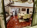 Elegant dining area with spiral staircase and decorative flooring