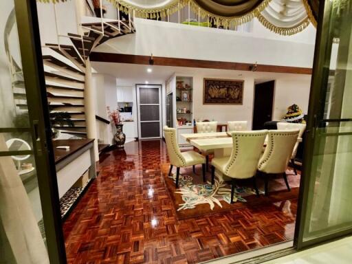 Elegant dining area with spiral staircase and decorative flooring