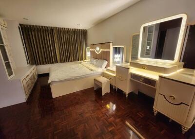 Elegant bedroom with classic furniture and hardwood flooring
