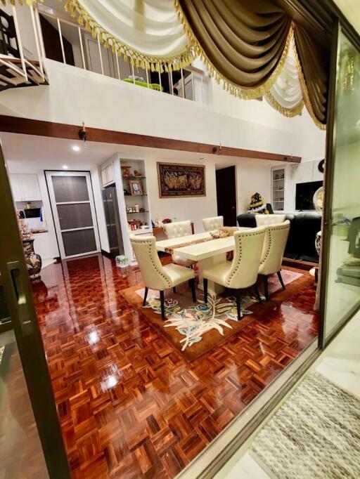 Spacious two-story living room with high ceiling and elegant interior design