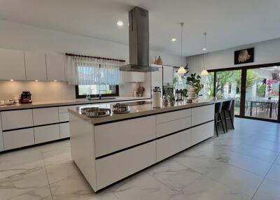 Spacious modern kitchen with central island and integrated appliances