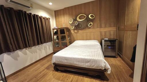 Cozy bedroom with wooden finish and artistic wall decor