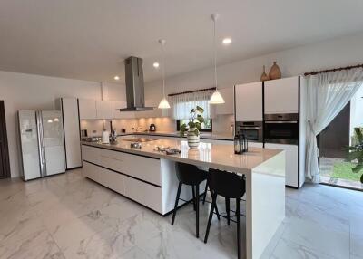 Spacious kitchen with modern appliances and island seating
