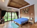 Spacious bedroom with wooden furniture and garden view