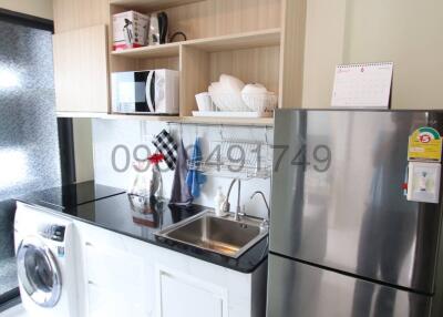 Modern kitchen with stainless steel appliances and wooden cabinets