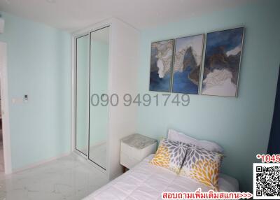 Cozy bedroom with light blue walls and modern artwork
