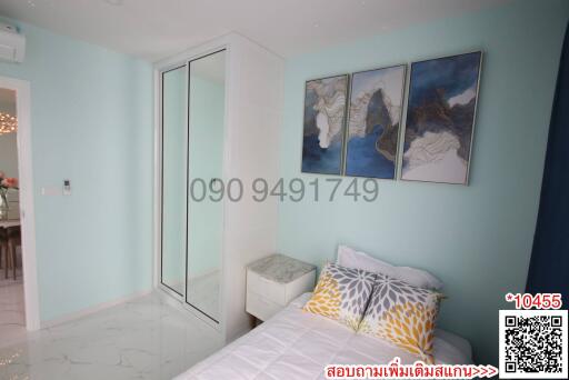 Cozy bedroom with light blue walls and modern artwork