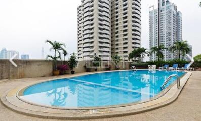 Residential complex with outdoor swimming pool and lounge chairs