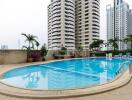 Residential complex with outdoor swimming pool and lounge chairs