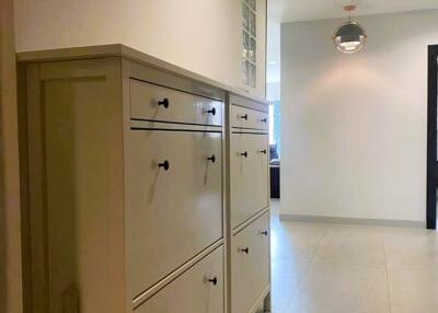 Spacious hallway with a white storage cabinet and tiled flooring