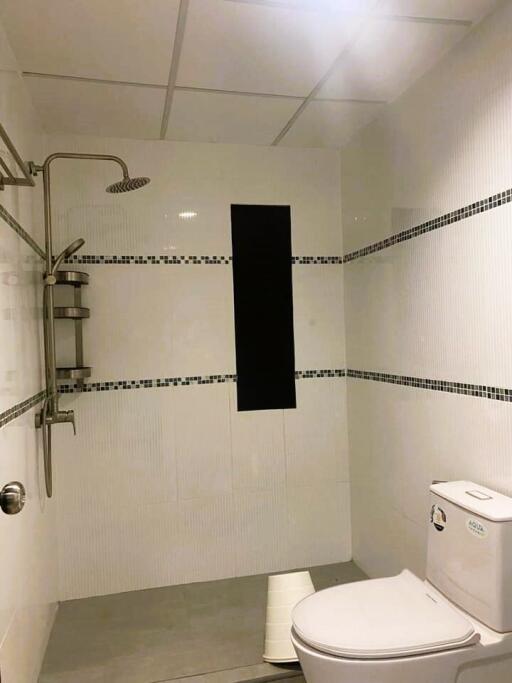 Modern bathroom with white tiling and black accents