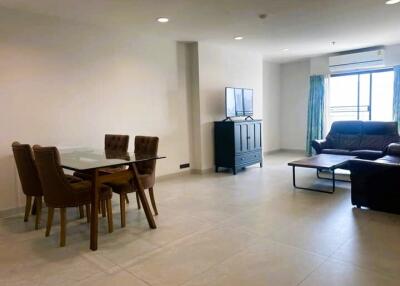 Spacious living room with dining area and natural light