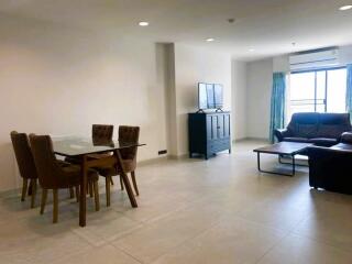 Spacious living room with dining area and natural light