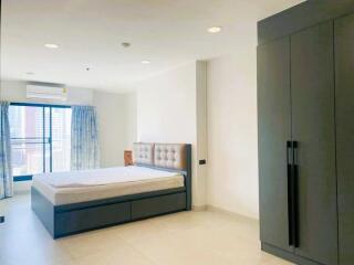 Bright and spacious bedroom with large bed and wardrobe