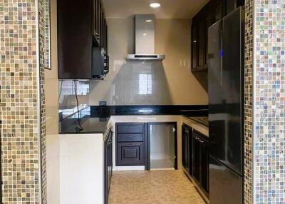 Modern kitchen with stainless steel appliances and mosaic tile backsplash