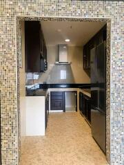 Modern kitchen with stainless steel appliances and mosaic tile backsplash