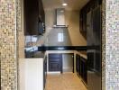 Modern kitchen with stainless steel appliances and mosaic tile backsplash