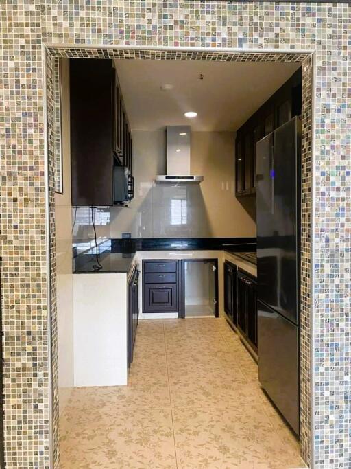 Modern kitchen with stainless steel appliances and mosaic tile backsplash