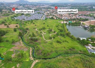 Aerial view of sprawling green property with potential for development