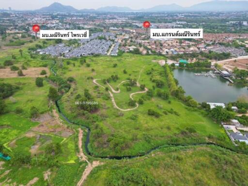 Aerial view of sprawling green property with potential for development