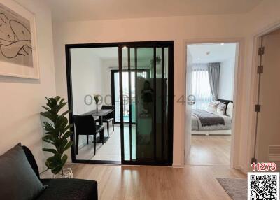 Modern living room with adjacent bedroom view through sliding doors