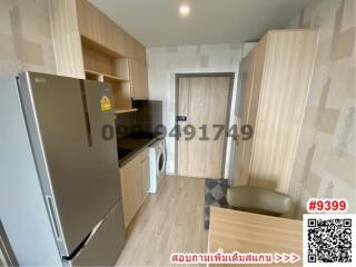 Compact modern kitchen with wood-finished cabinets and equipped with appliances