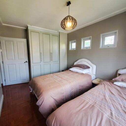 Cozy bedroom with twin beds and ample natural light