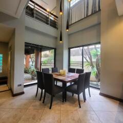 Spacious dining room with high ceiling and natural light