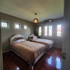 Spacious Bedroom with Twin Beds and Large Windows