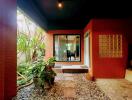 Cozy patio area with red accent walls and natural stone path