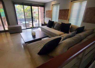 Contemporary living room with large windows and comfortable seating