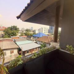 Urban view from residential balcony showcasing surrounding buildings and clear sky