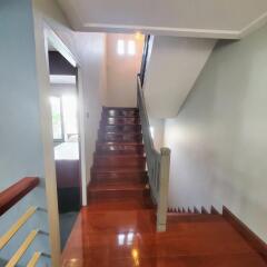 Wooden staircase with polished floor leading to the upper level of a home