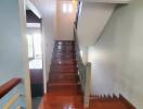 Wooden staircase with polished floor leading to the upper level of a home