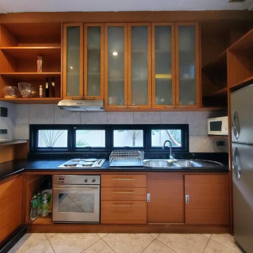 Modern kitchen with wooden cabinets and stainless steel appliances