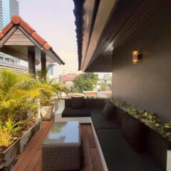 Cozy balcony with seating area and potted plants