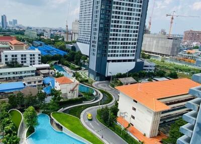 Modern high-rise residential building with swimming pool and landscaped grounds