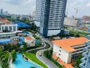 Modern high-rise residential building with swimming pool and landscaped grounds