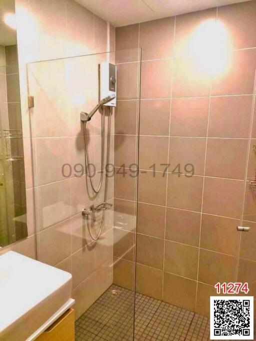 Modern bathroom interior with glass shower and tiled walls