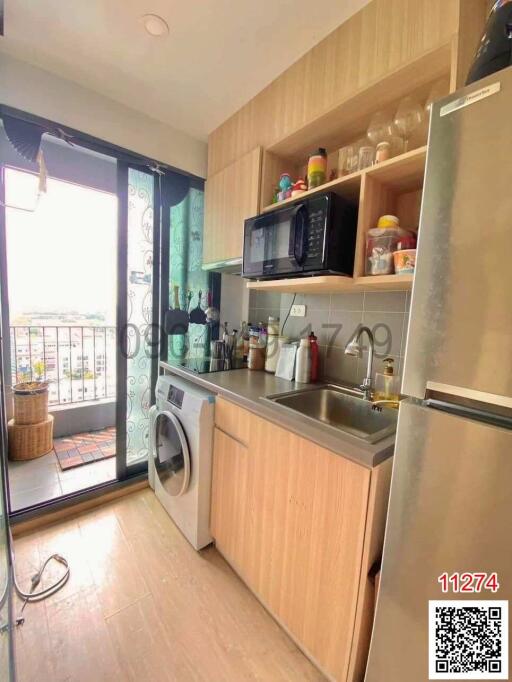 Compact modern kitchen with natural light and balcony access